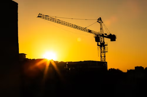 Urban skyline and tower crane at golden hour